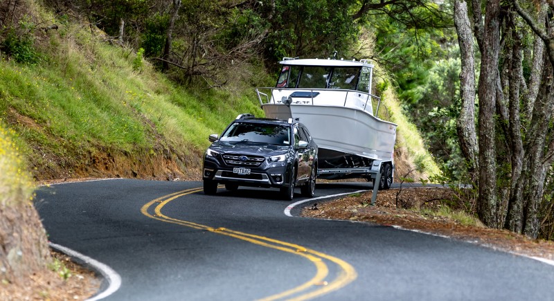 Outback XT towing boat on road