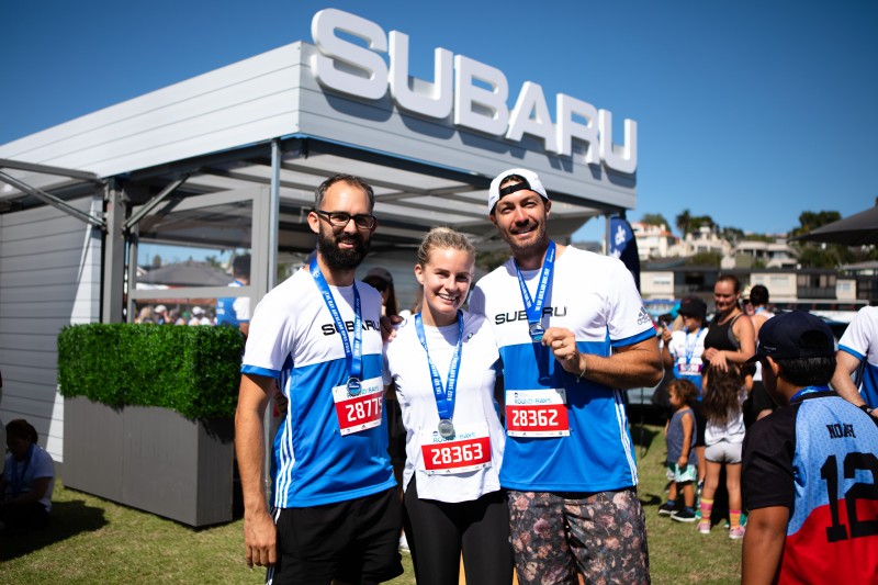 Art Green and Matilda Green with friend David at the Subaru stand for Round the Bays 2019. 