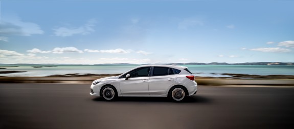 Subaru Impreza driving by the ocean