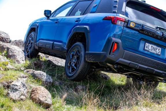 Subaru Outback Wilderness in Geyser Blue driving on rocks